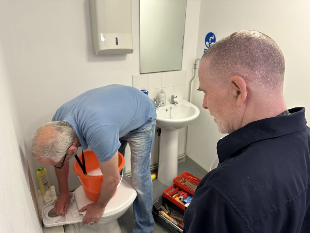 Kevin and Alan fixing the flush on the loo